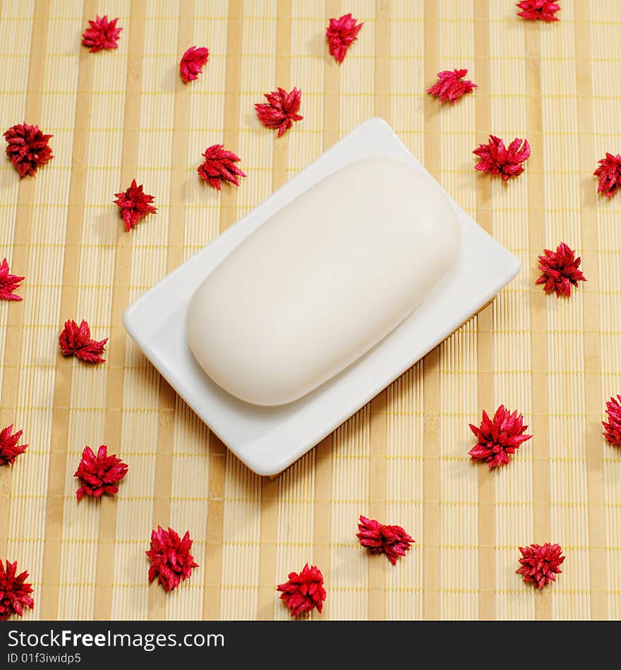 Soap dish with soap on top of a bamboo mat. Soap dish with soap on top of a bamboo mat.