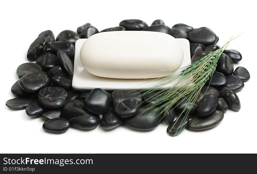 Soap dish on top of rocks against white. Soap dish on top of rocks against white.