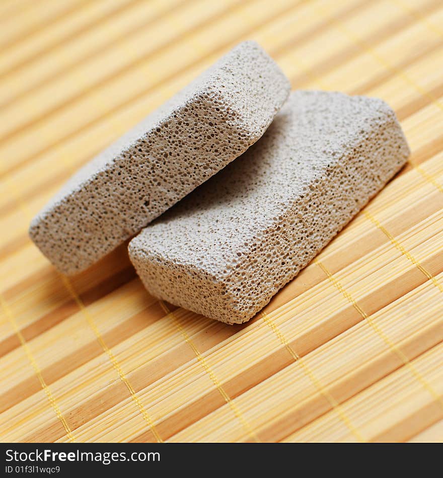 Pumice stones on display on a bamboo mat. Pumice stones on display on a bamboo mat.