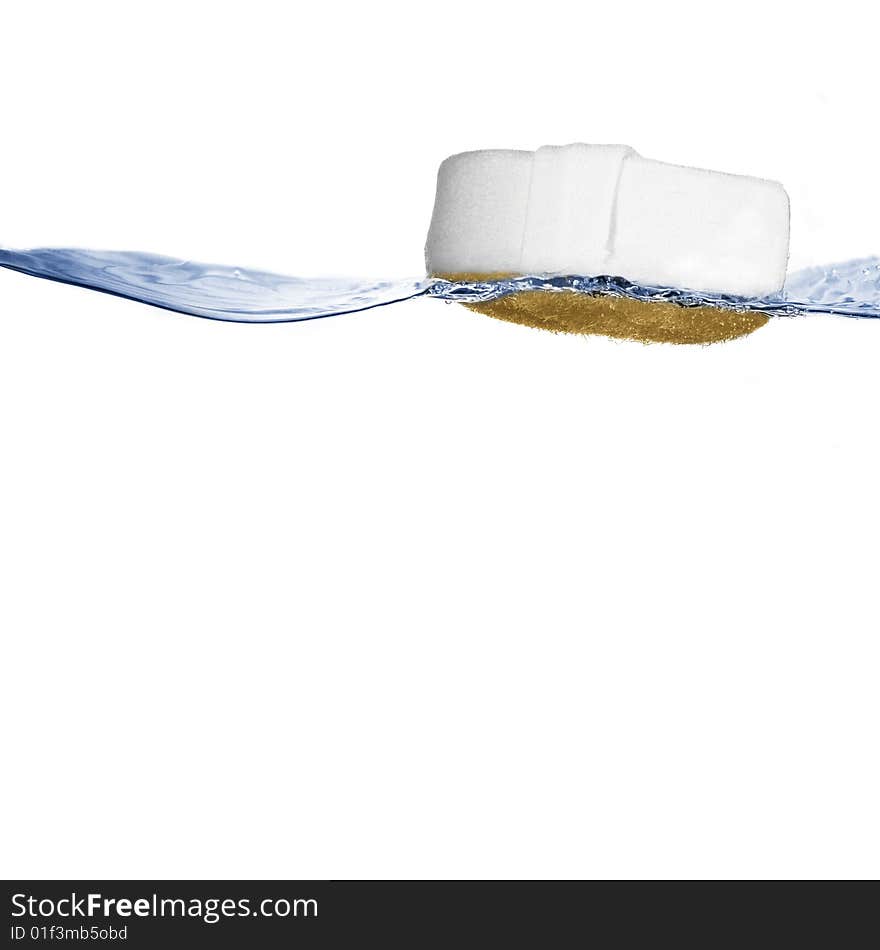 Sponge floating on crisp clear water against white. Sponge floating on crisp clear water against white.