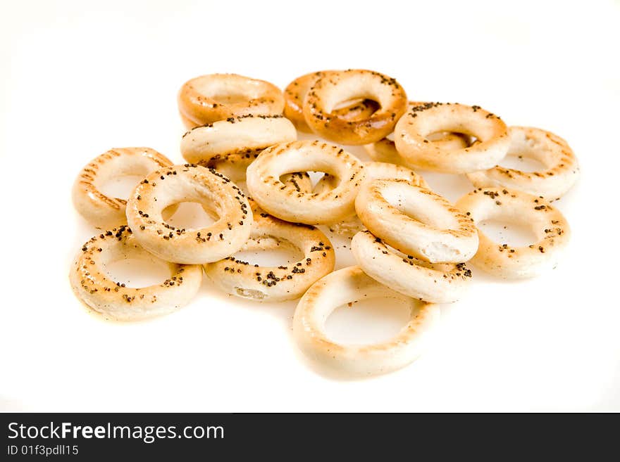 Heap of bread-rings on white ground