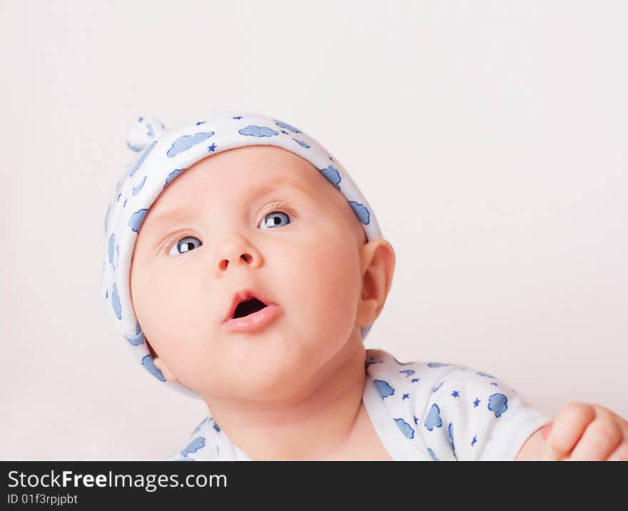 Small cute surprised child in blue pajama