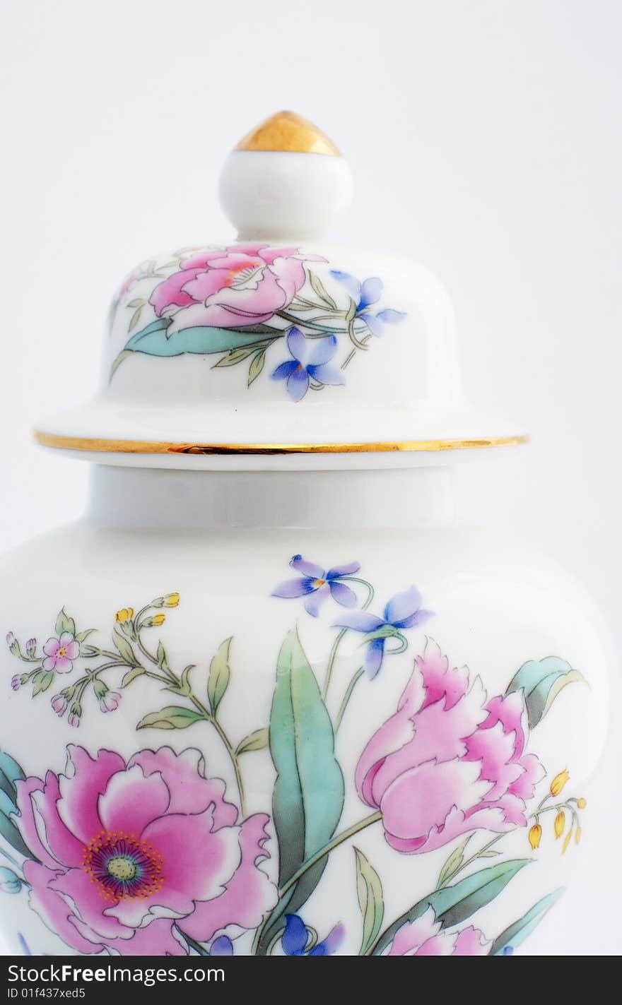 Oriental ginger jar with a floural motiff.  Roses and other colorful flowers adorn the front of the jar, the lid has a gold top and a gold rim.