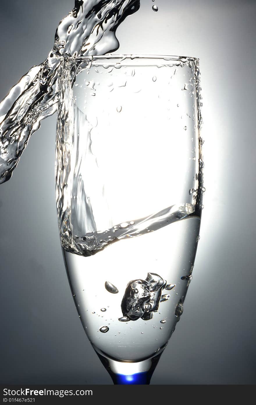 Glass with liquid in slow-motion shot.