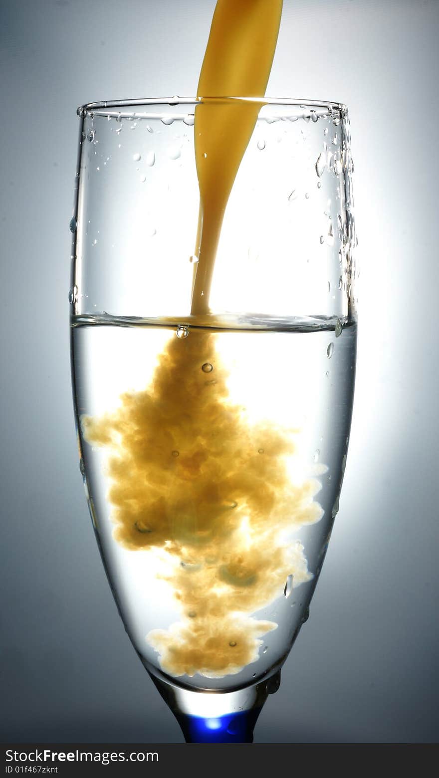 Glass with liquid in slow-motion shot.