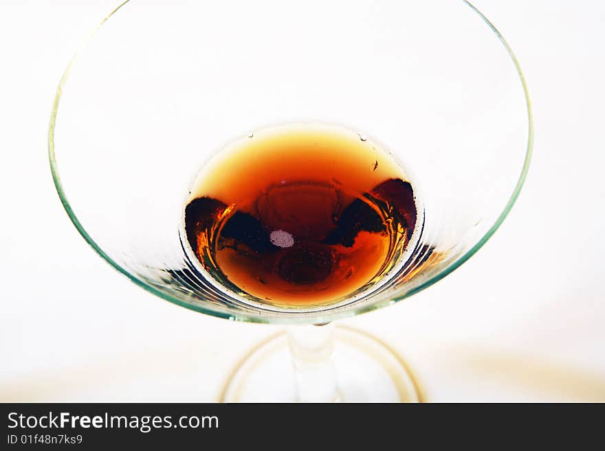 Wine being poured into a wine glass on white background