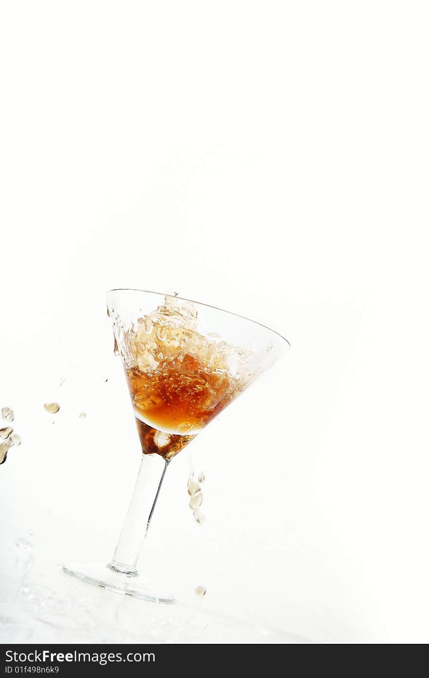 Wine being poured into a wine glass on white background