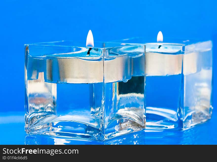 Blue candles in glass