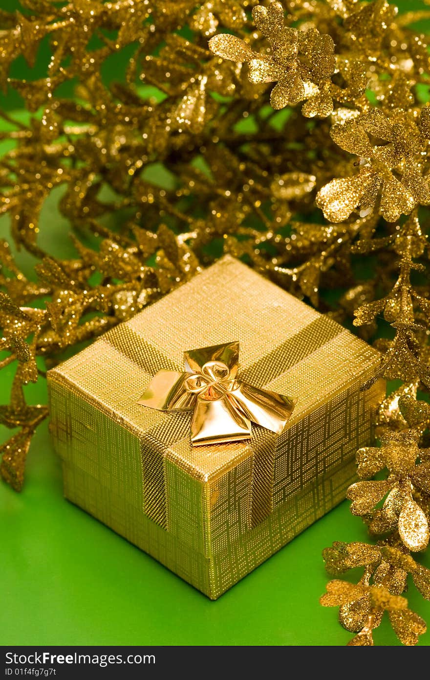 Golden gift box with decoration leaves