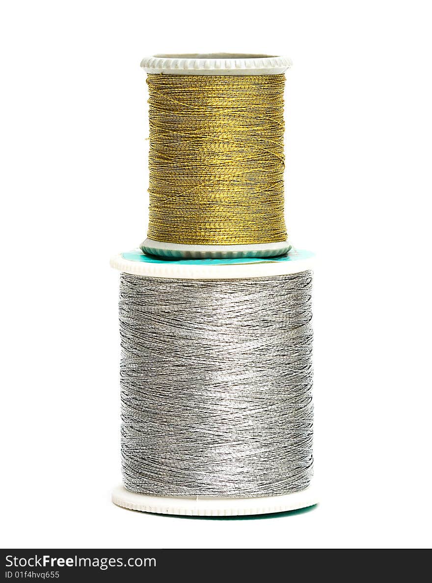 Golden and silver spools of threads