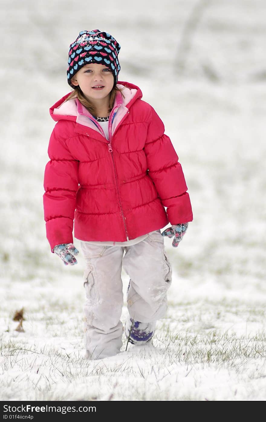 A cute little girl walking in the snow. A cute little girl walking in the snow