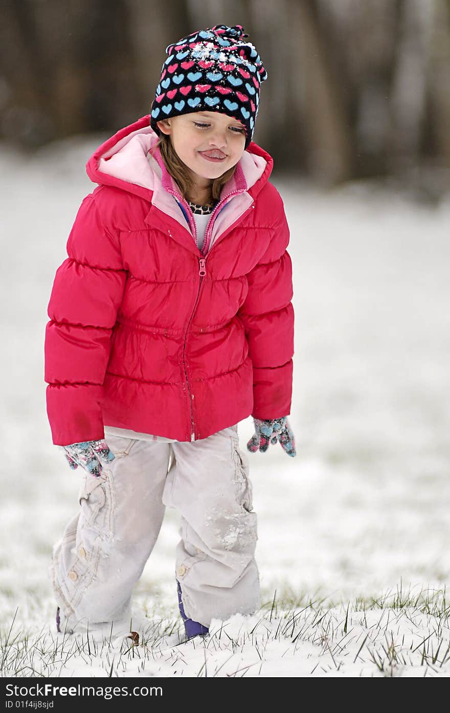 A cute little girl walking in the snow. A cute little girl walking in the snow