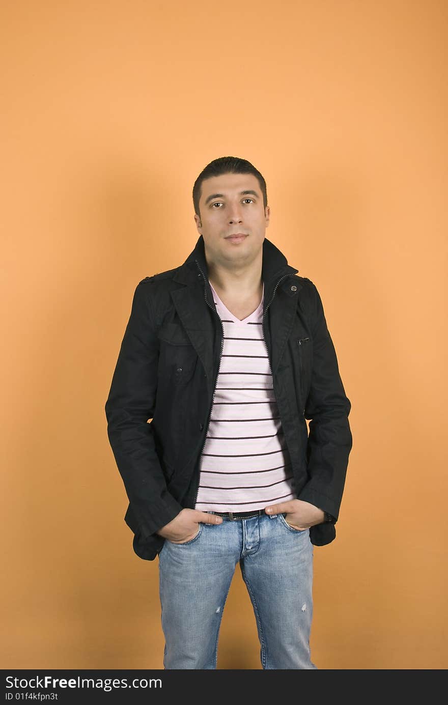 Young man in black jacket with hands in pocket jeans. Young man in black jacket with hands in pocket jeans