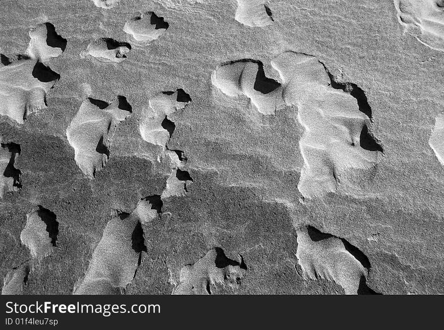 A close-up image of sand. Black and white texture. A close-up image of sand. Black and white texture.