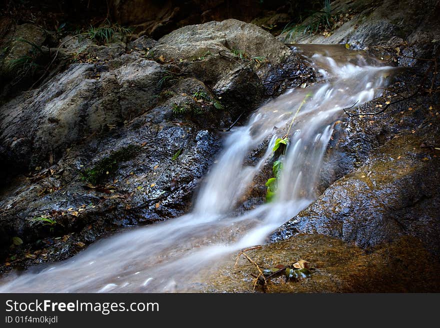 A shallow channel cut in the surface of soil or rocks by running water. A shallow channel cut in the surface of soil or rocks by running water