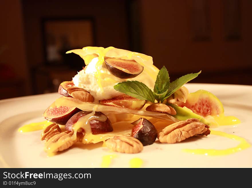 Phyllo pastry with fruit and nuts covered in a lemon sauce and a peppermint leaf