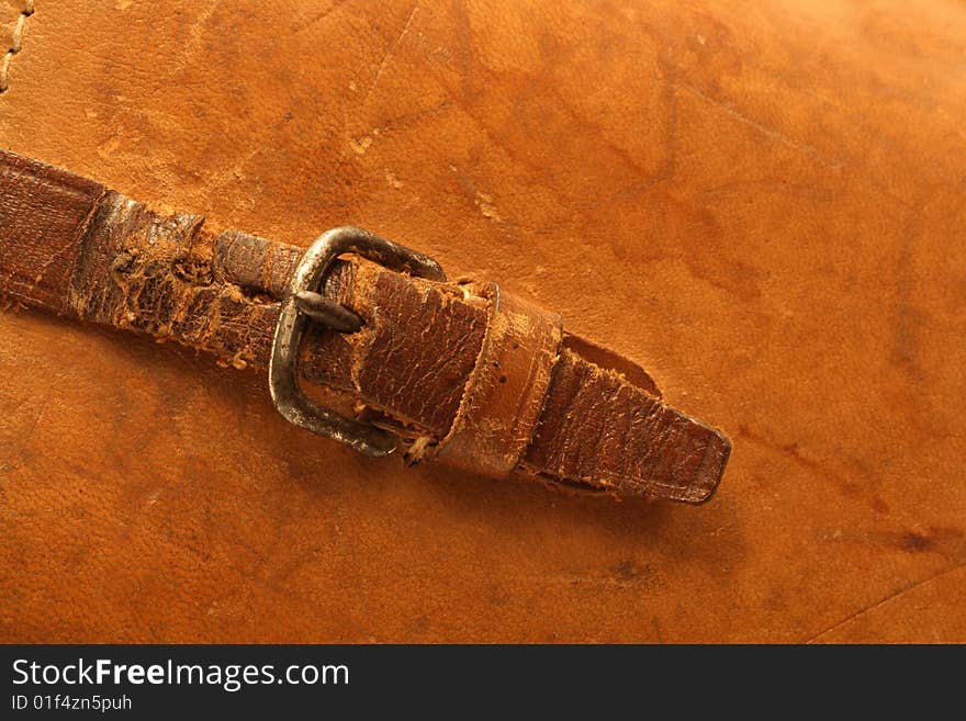 Ginger leather background with ancient buckle and belt