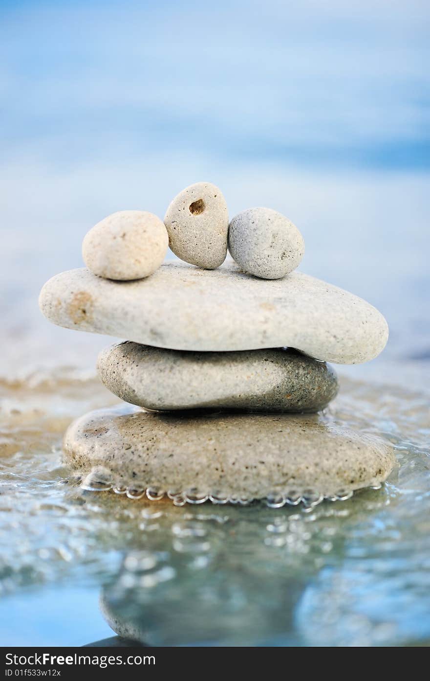 Sea pebble and quiet waves on a summer beach. Sea pebble and quiet waves on a summer beach