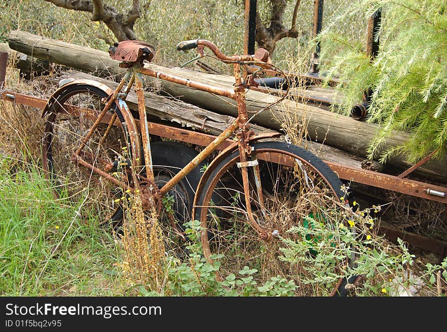 Old rusty bicycle, forgotten near the house in the Italian mountains. Old rusty bicycle, forgotten near the house in the Italian mountains