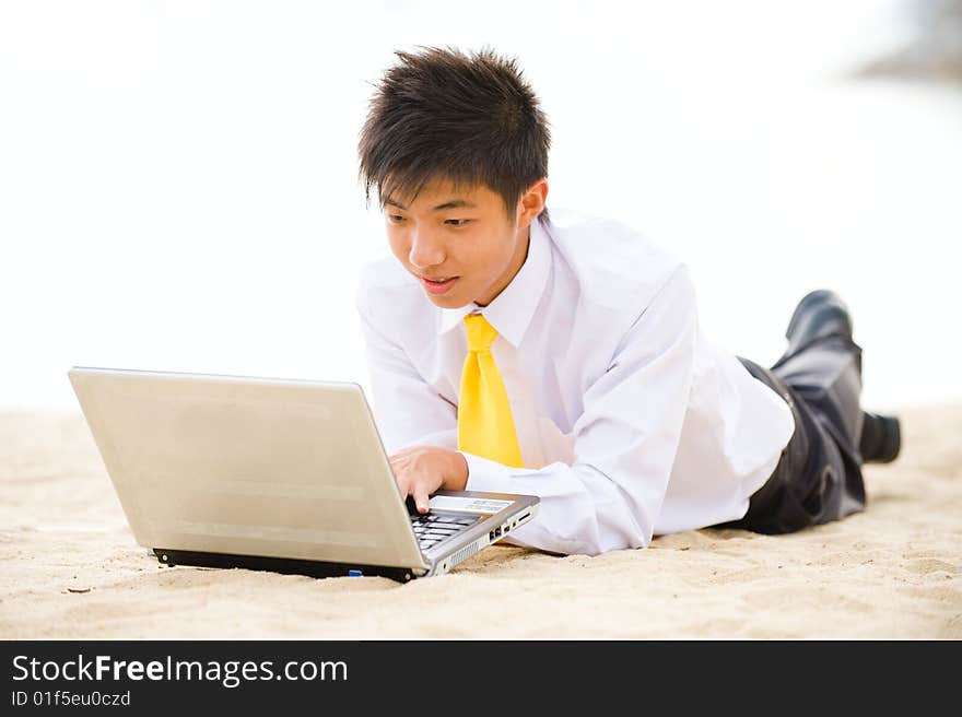 A young business using computer at the beach