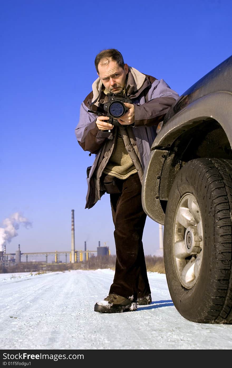 Photographer during winter outdoor session. Photographer during winter outdoor session.