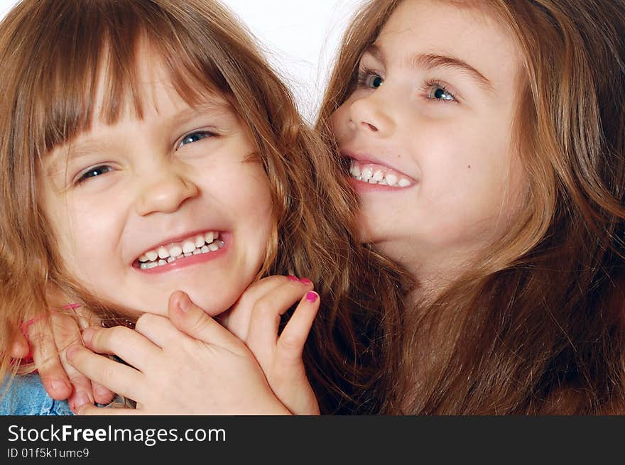 Two little 4 year old laughing playful girls. Close-up. Two little 4 year old laughing playful girls. Close-up.