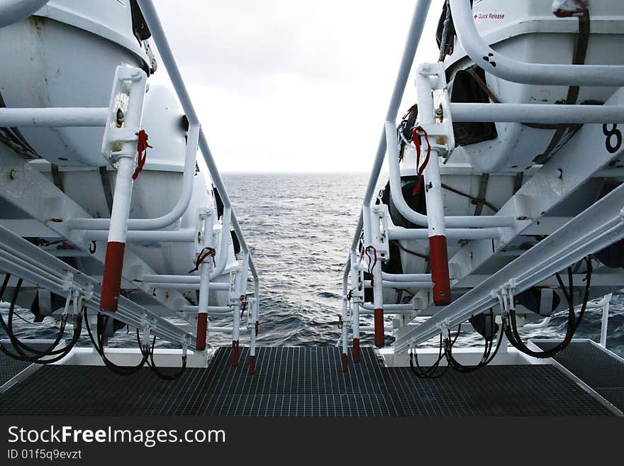 A row of life rafts arranged and ready to use on a large passenger ship