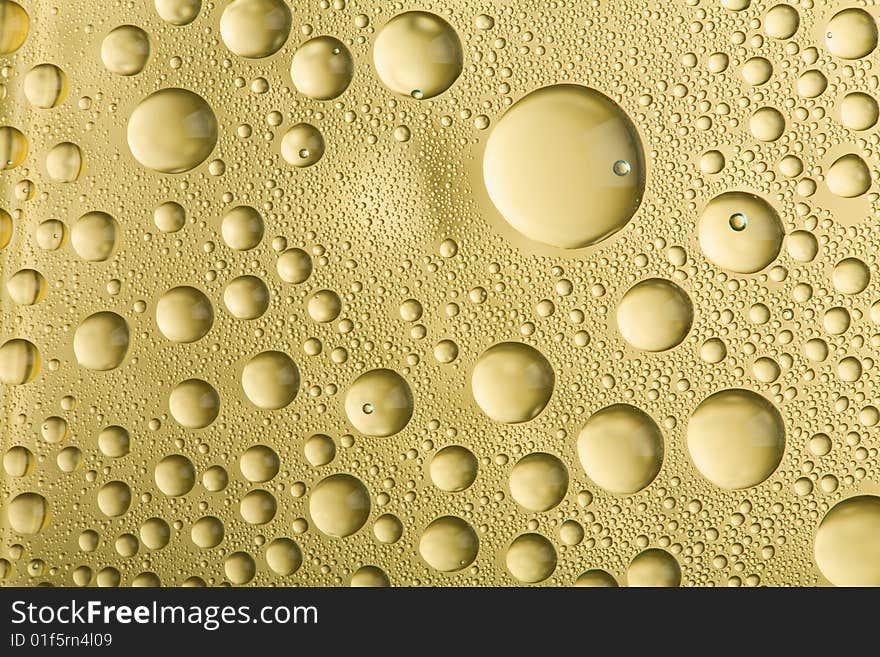 Macro of golden water drops. Macro of golden water drops