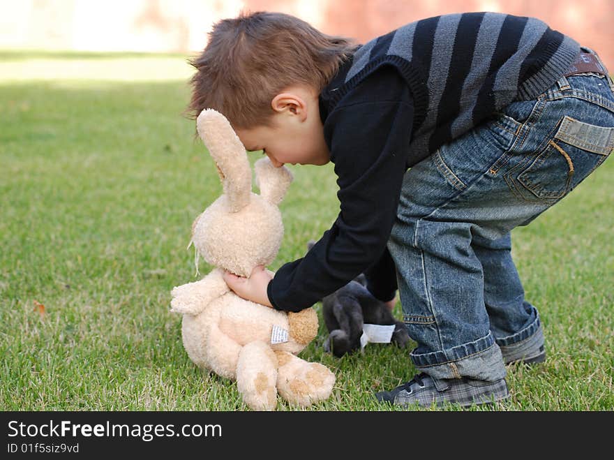 Little boy with a toy hare in hands. Little boy with a toy hare in hands