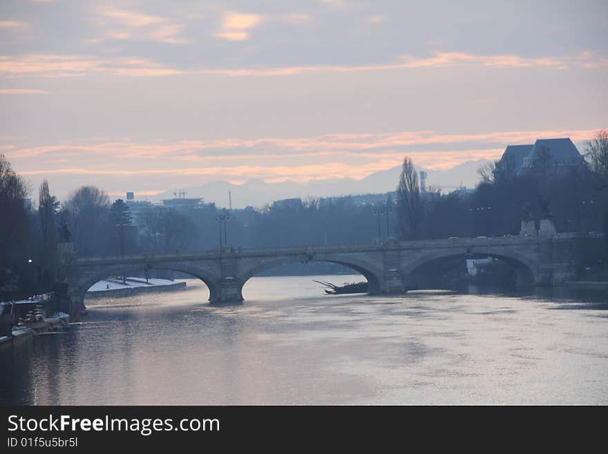 View of Turin bridge at sunset on river Po