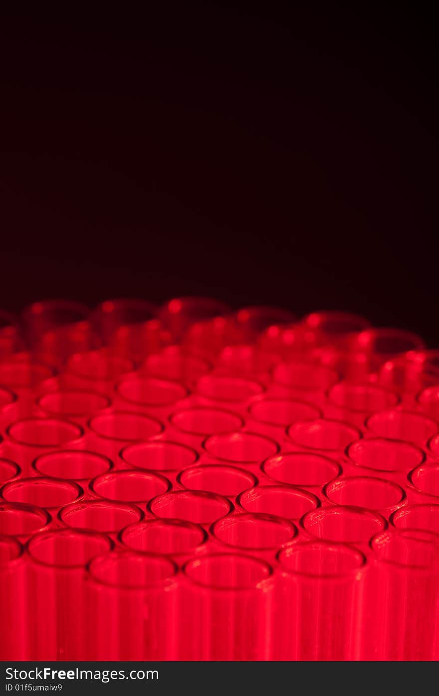 Close-up of empty test tubes in red