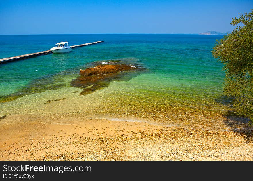 Boat at the berth, clear sea