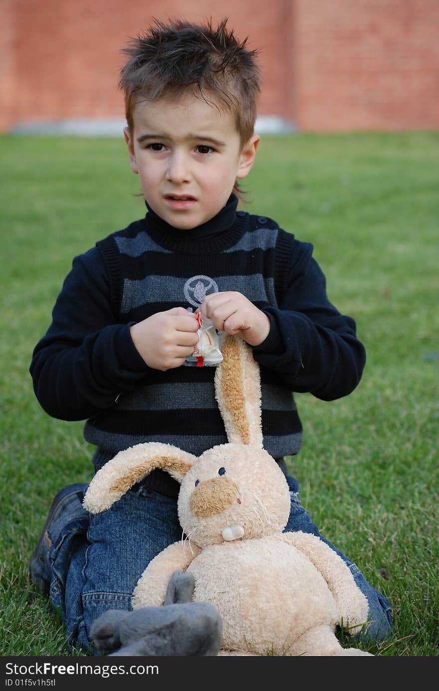 Little boy with a toy hare in hands. Little boy with a toy hare in hands