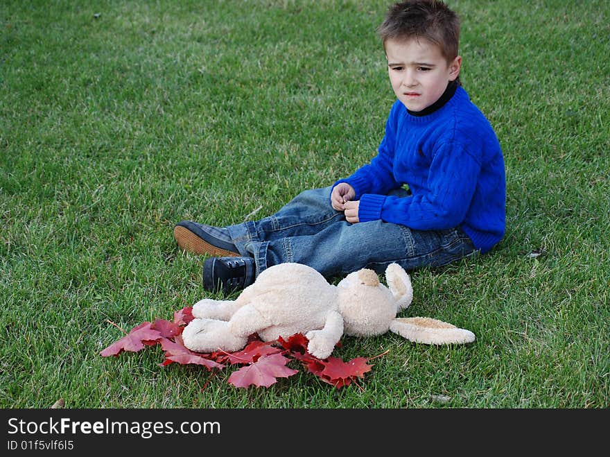 Little boy with a toy hare in hands. Little boy with a toy hare in hands