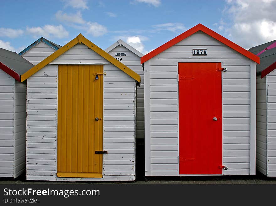 Wooden beach huts with multi colored doors