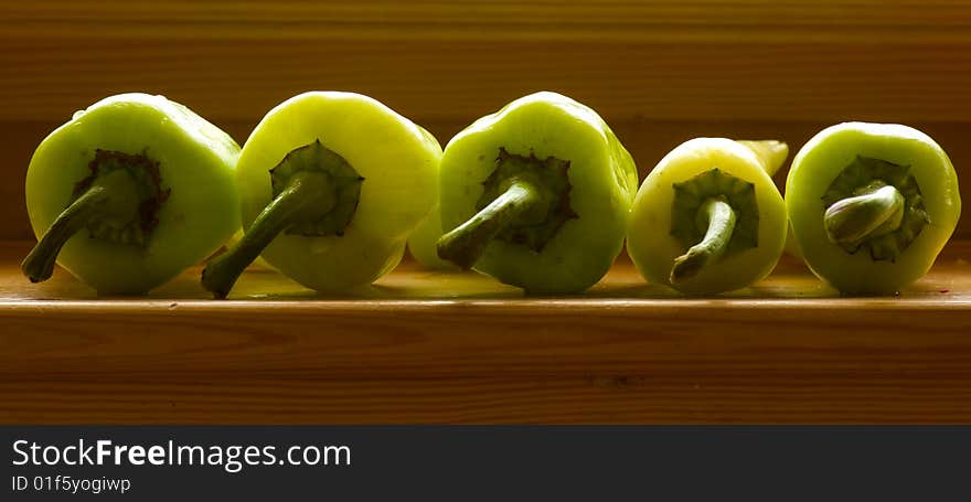 Still life with five pepper on wood