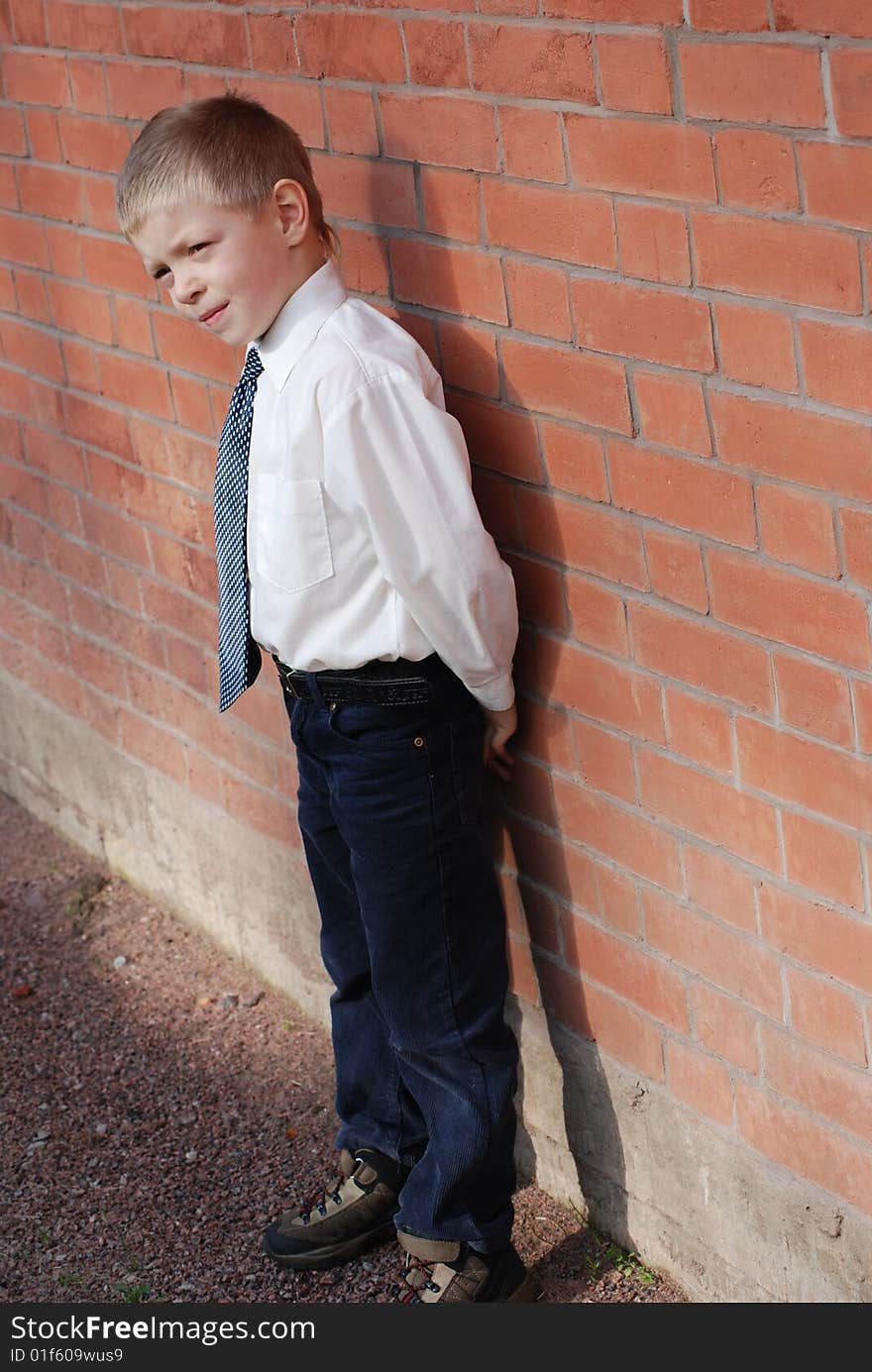 Boy on a background a brick wall