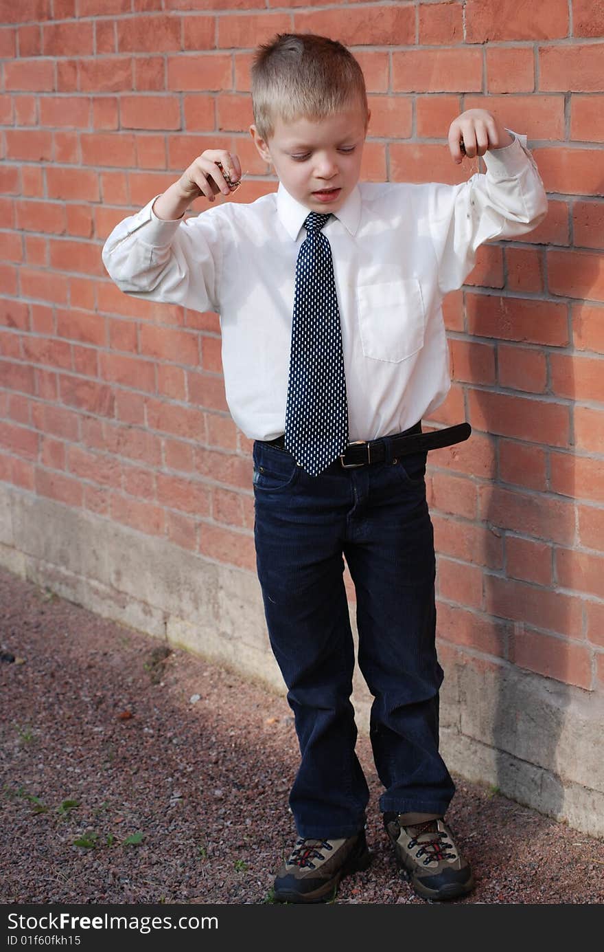 Boy on a background a brick wall