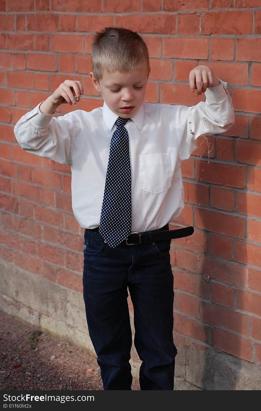 Boy on a background a brick wall