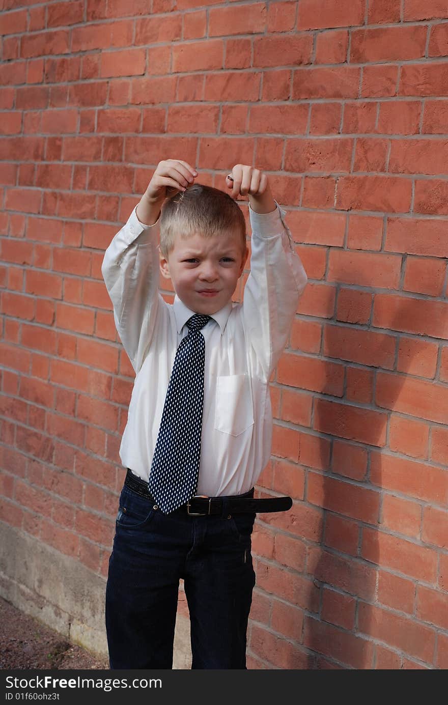 Boy on a background a brick wall