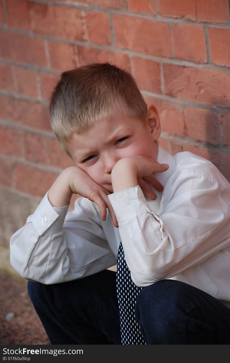 Boy on a background a brick wall