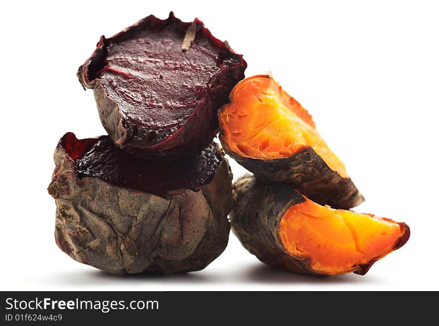 Grilled beet and carrot cut into pieces and stacked in a pile. Isolated on a white background. Grilled beet and carrot cut into pieces and stacked in a pile. Isolated on a white background.