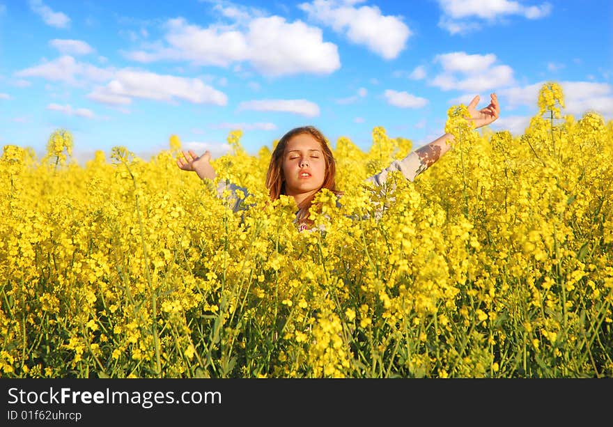 Teenager relaxing in a rape field. Teenager relaxing in a rape field