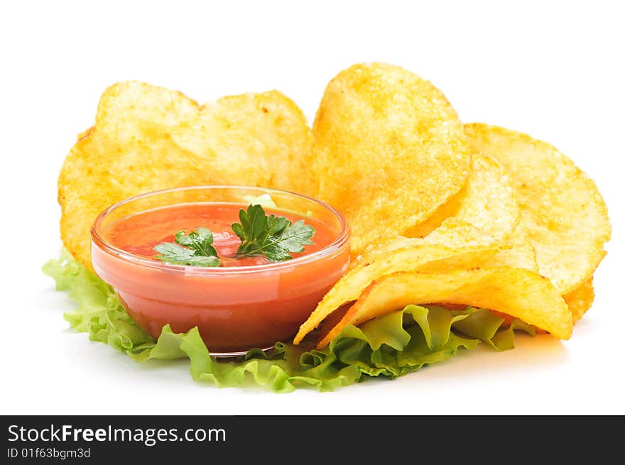 Potato chips and ketchup on a lettuce. Isolated on a white background&