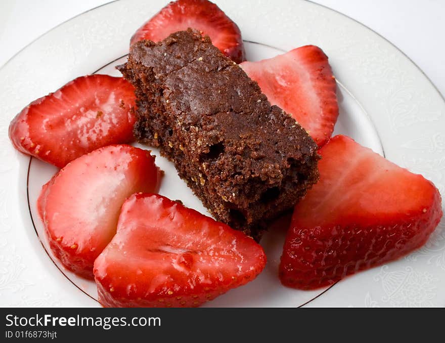 Strawberries sliced with cake on saucer. Strawberries sliced with cake on saucer