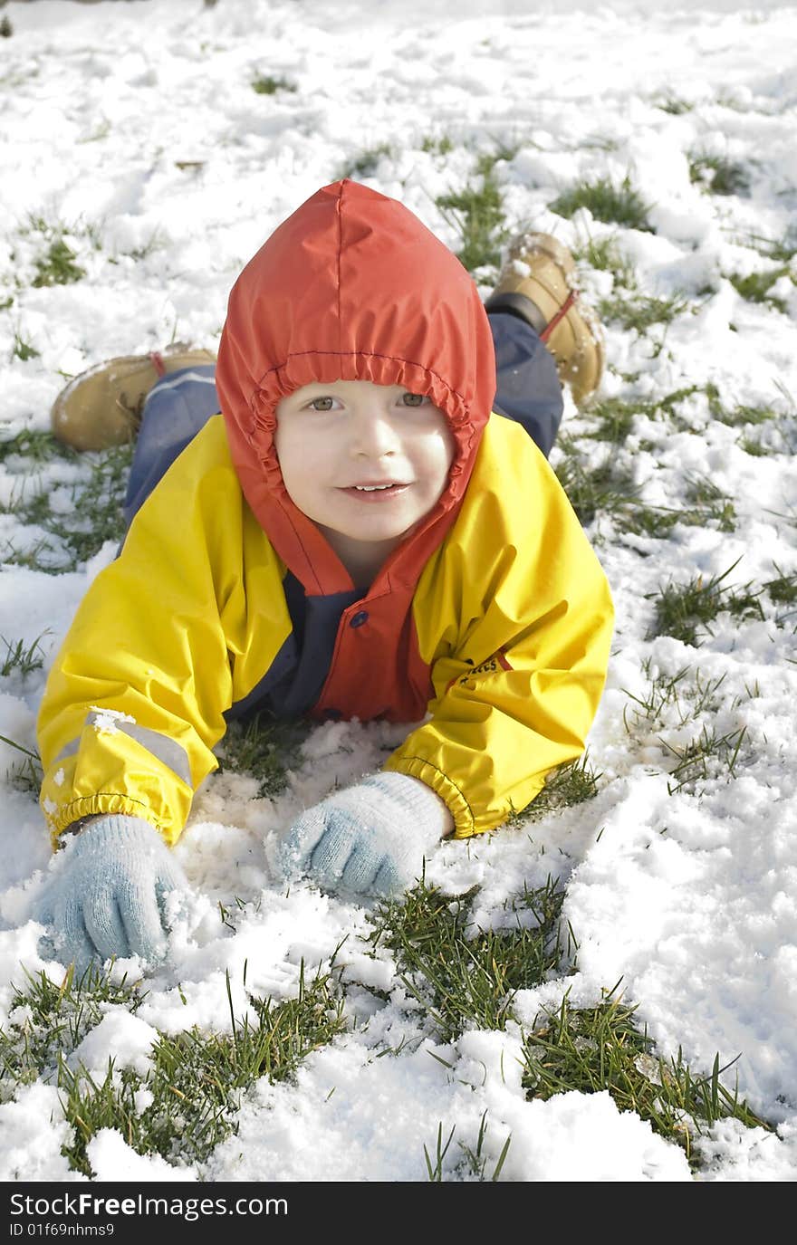 A little boy plays outside in his garden during the heavy snowfall in southern england 2009. A little boy plays outside in his garden during the heavy snowfall in southern england 2009.