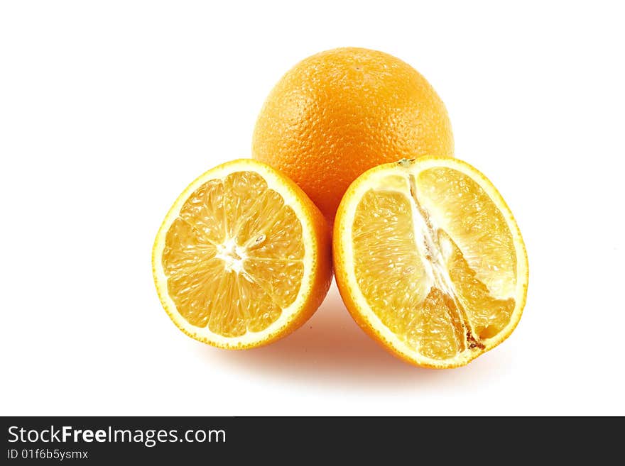 The whole orange and two halves of an orange. On a white background. The whole orange and two halves of an orange. On a white background