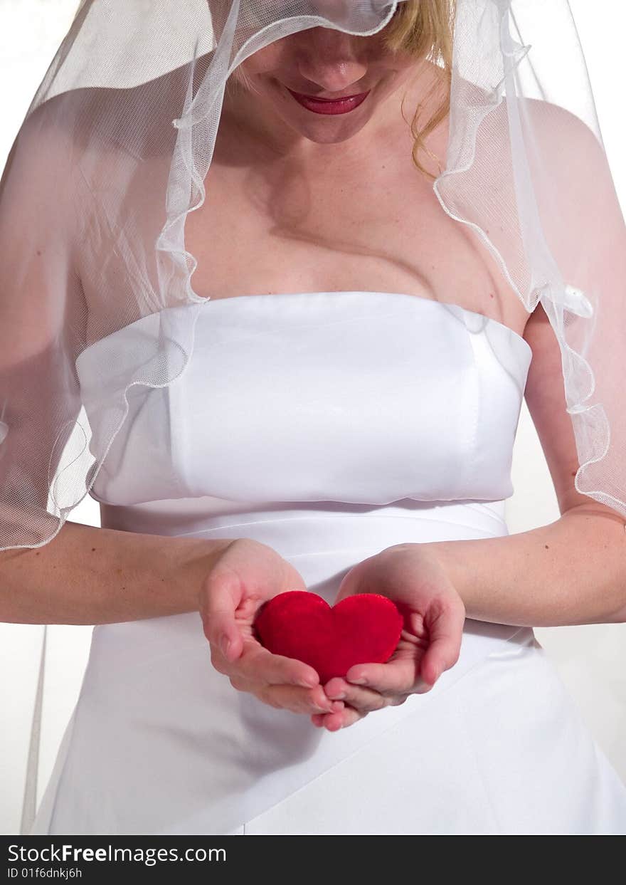 Beauty bride keeps in hand heart