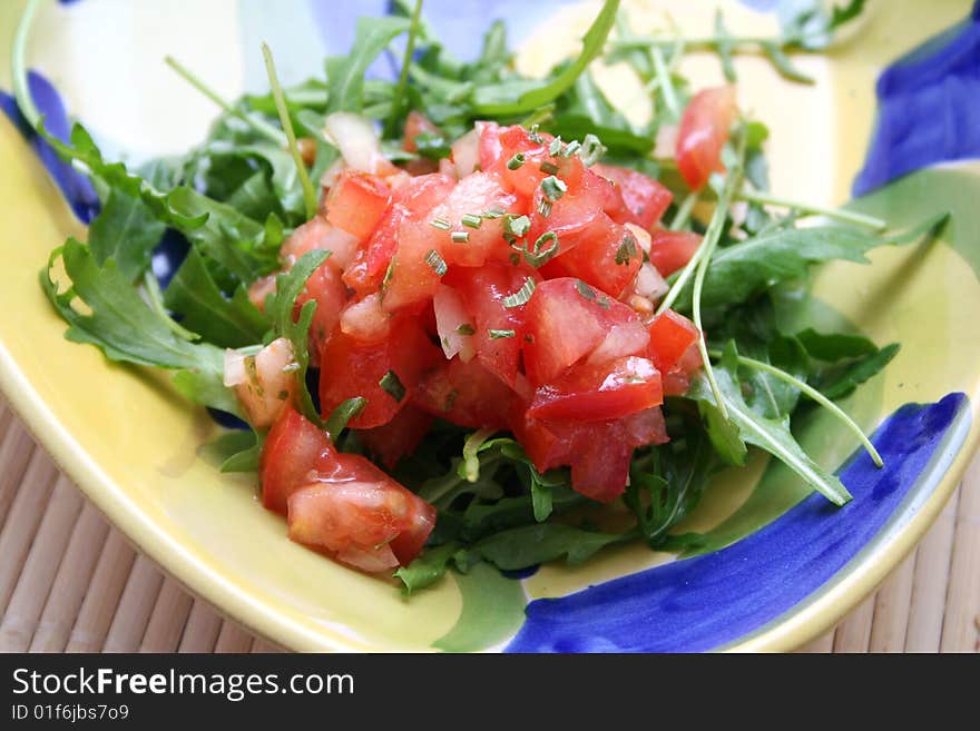 A fresh salad of tomatoes and rucola salad