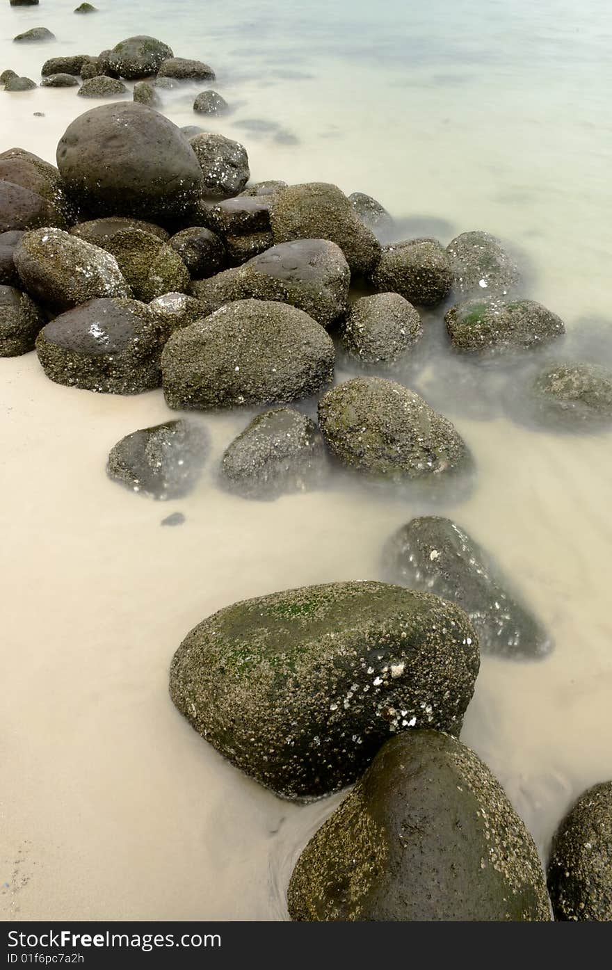 Long exposure of a rocky shoreline at ebbing tide